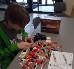 child builds model of the Titanic with building blocks