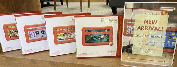 4 Launchpads on a shelf with a sign that says 