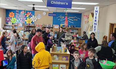 children & adults hunt for eggs in the library