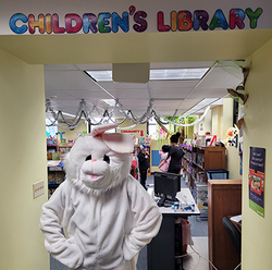 Easter bunny in front of children's library